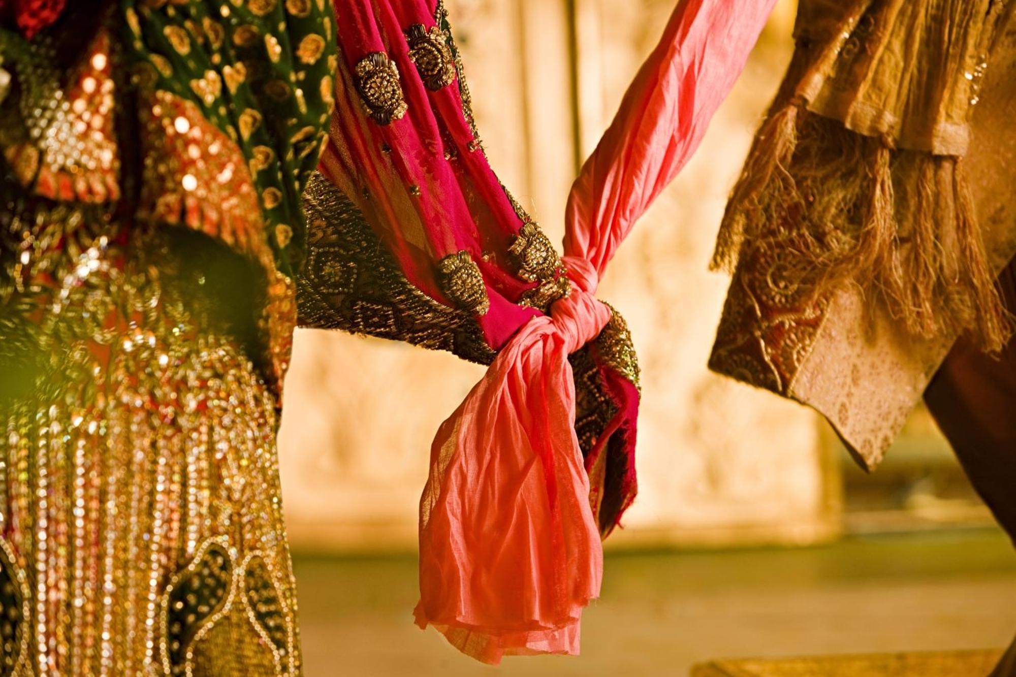 JW Marriott Hotel New Delhi Aerocity Exteriör bild The bride and groom hold hands during the wedding ceremony.